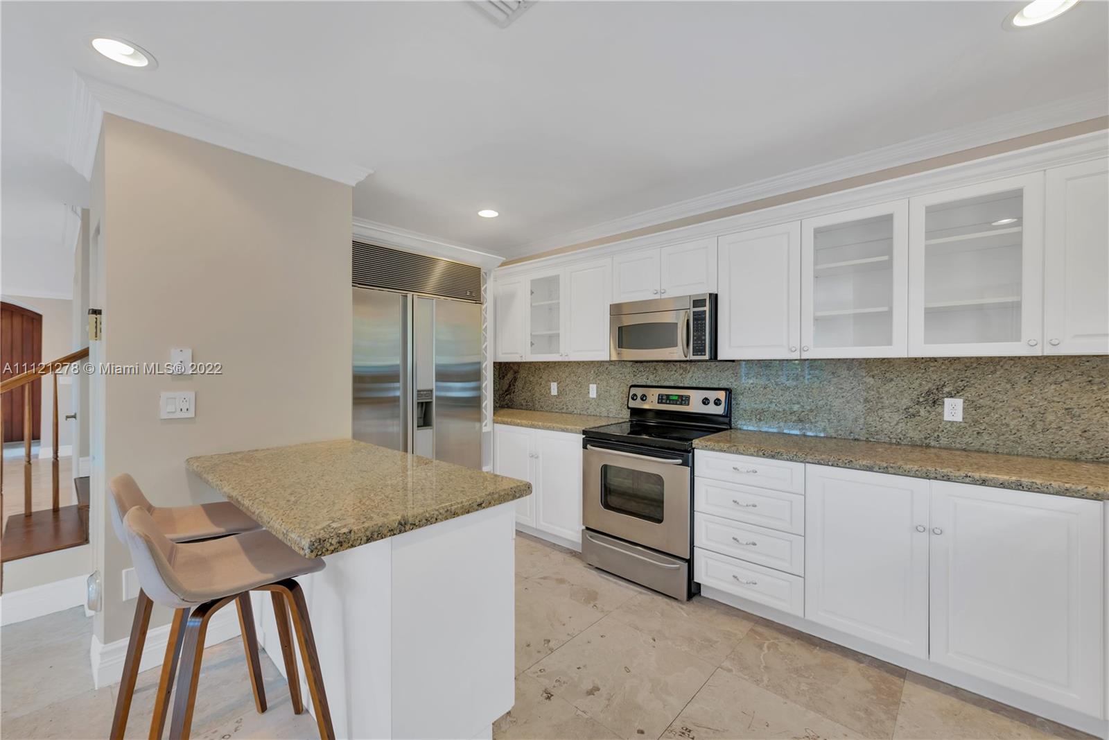 270 Fernwood Road Key Biscayne, FL 33149 - Photo 8 of 23 a kitchen with granite countertop a stove sink and microwave