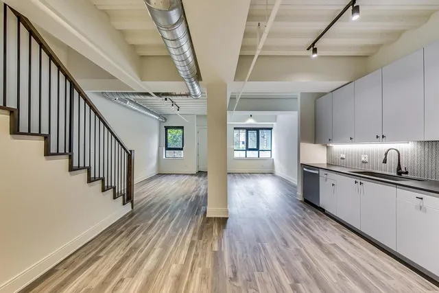 a view of a room with wooden floor