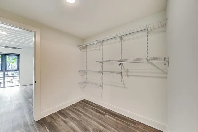 a view of a room with wooden floor and white walls