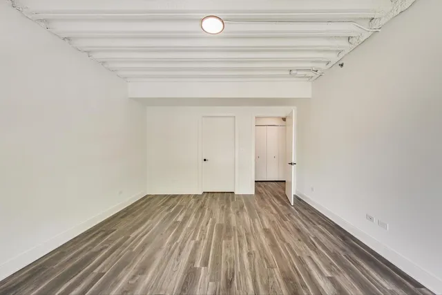 a bathroom with a granite countertop sink a toilet and a mirror