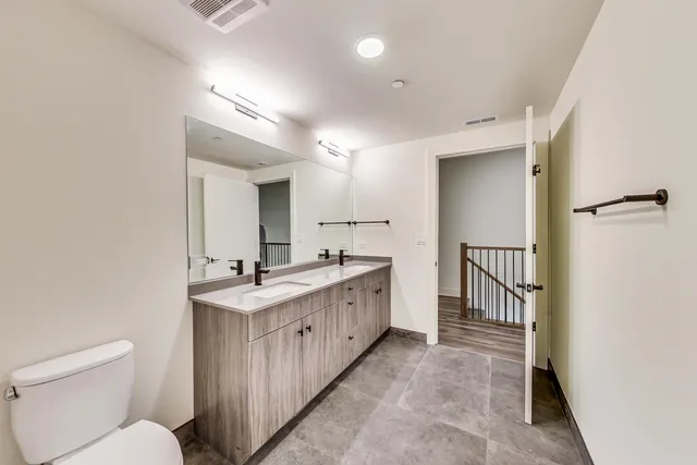 a view of a room with wooden floor and a ceiling fan