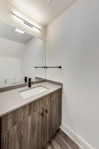 a large kitchen with stainless steel appliances granite countertop a lot of counter space and wooden floors