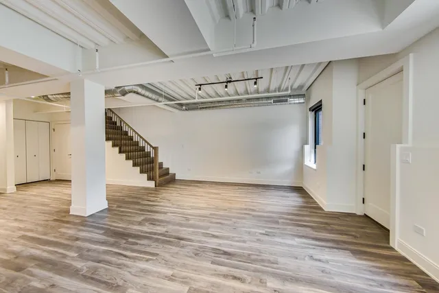 a kitchen with granite countertop wooden floors and stainless steel appliances