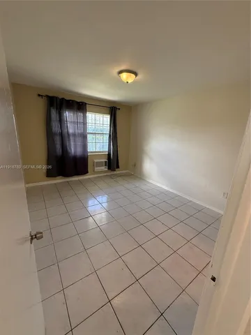 a view of an empty room and window