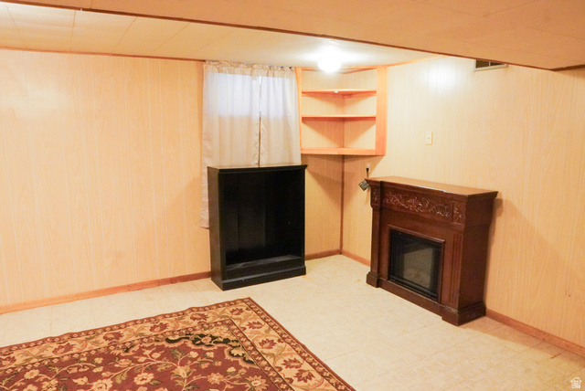 324 Stringtown Road Georgetown, ID 83239 - Photo 38 of 49 Unfurnished living room with wooden walls and a glass covered fireplace