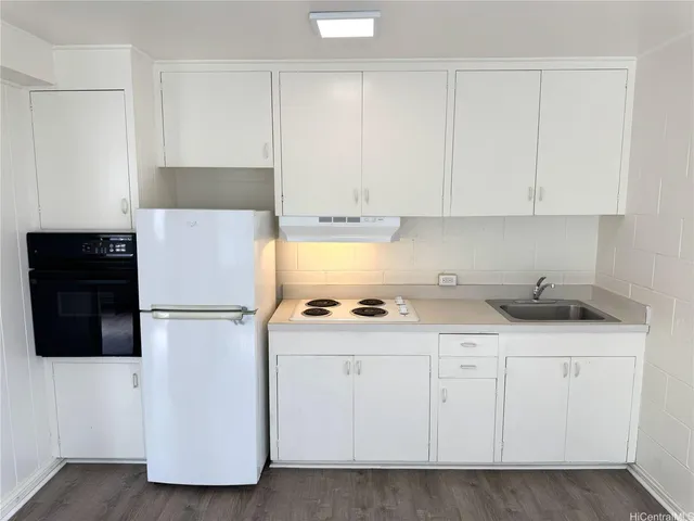 a utility room with cabinets washer and dryer
