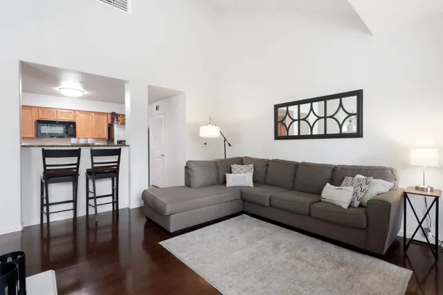 a living room with furniture and wooden floor