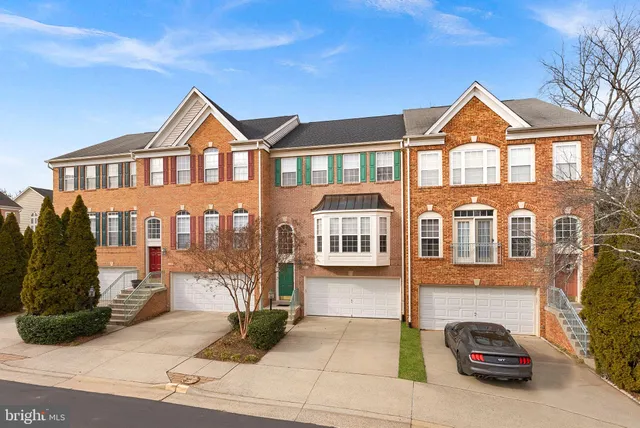 a front view of a residential apartment building with a yard