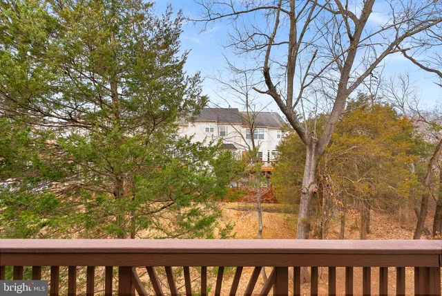 a view of a porch with a door and wooden floor