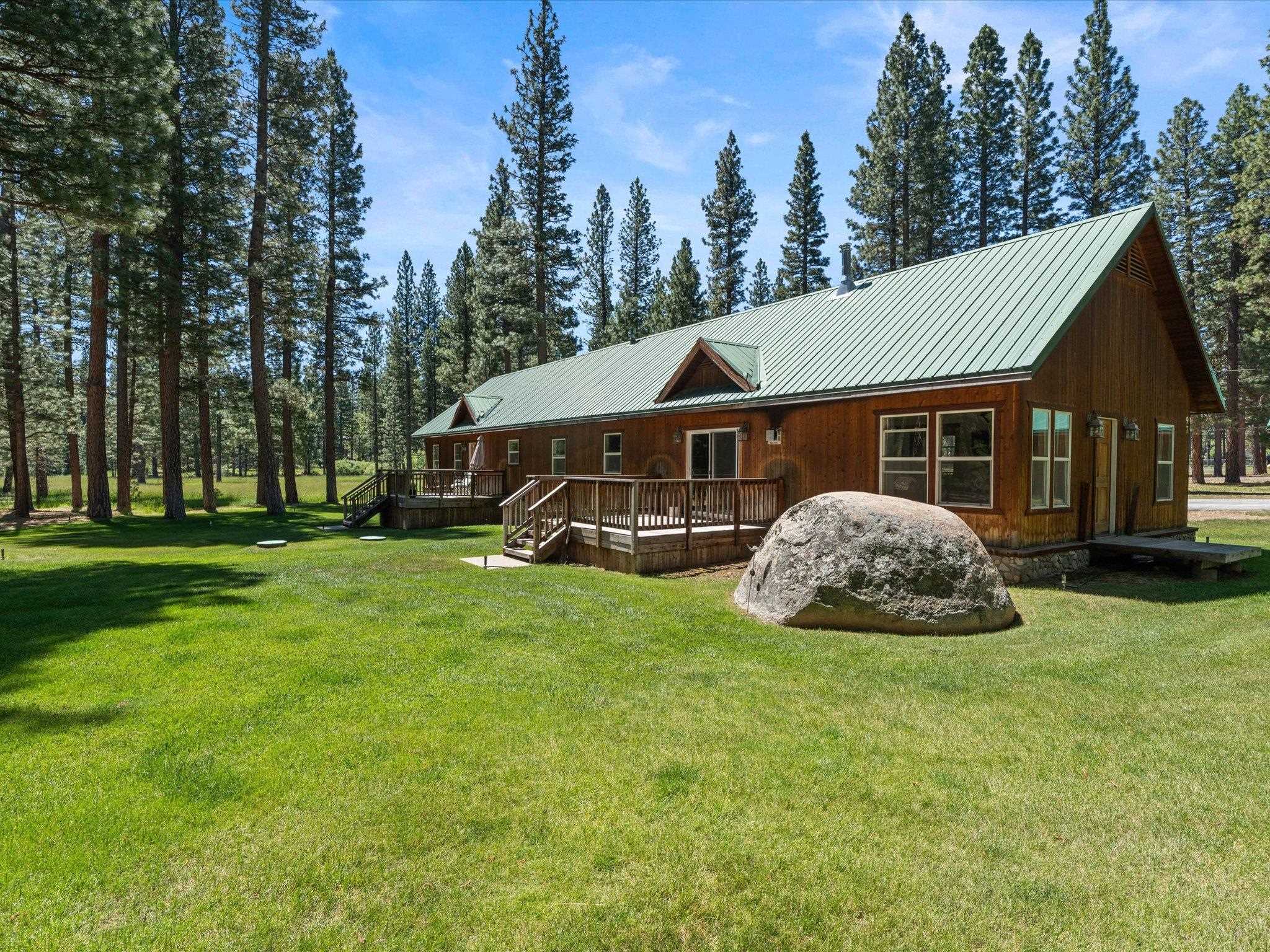 97 Main Street Calpine, CA 96124 - Photo 5 of 43 a front view of a house with a garden and trees