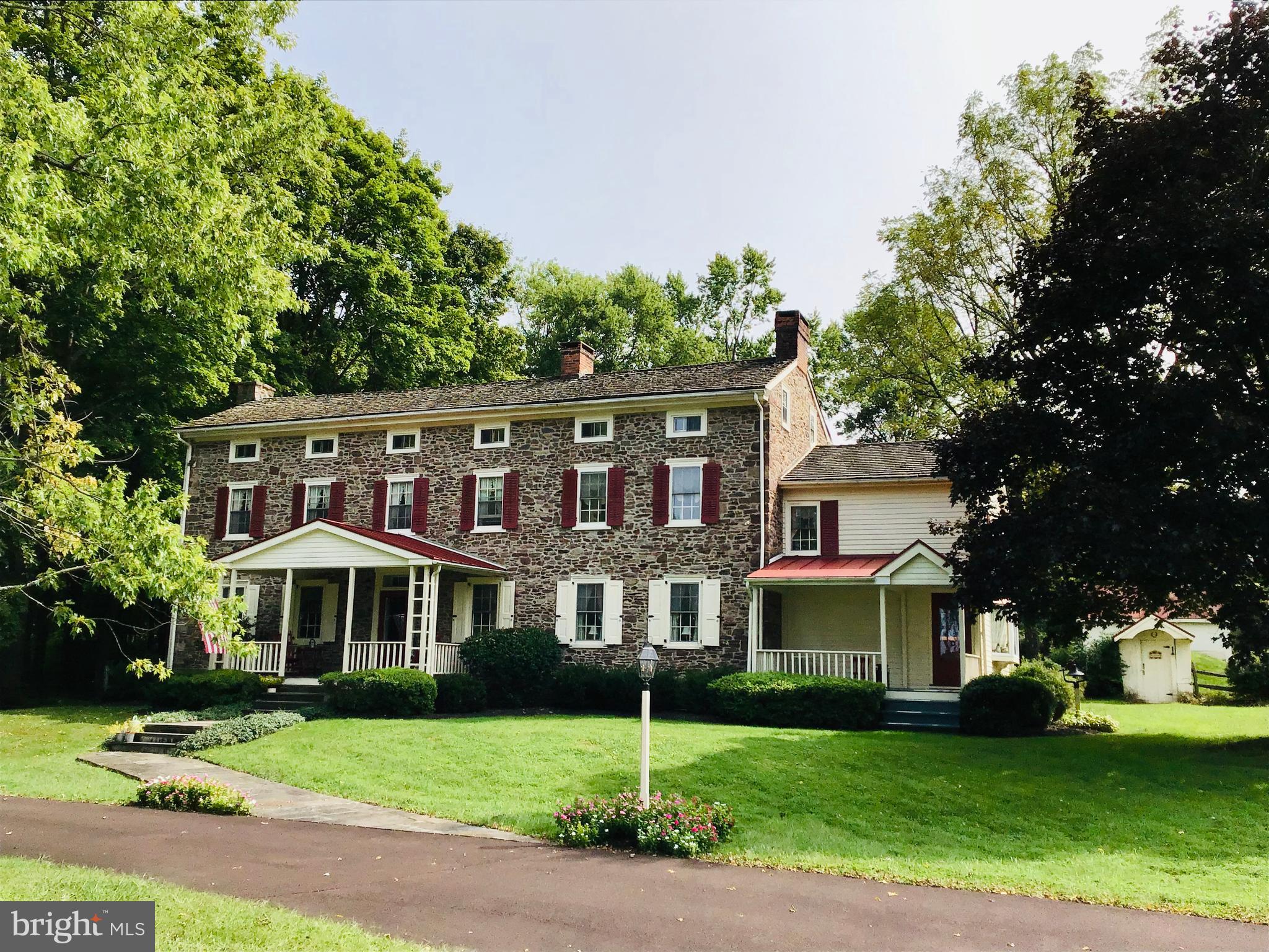Down a tree-lined drive...this fieldstone beauty