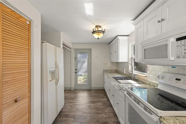 a kitchen with a sink stove and cabinets