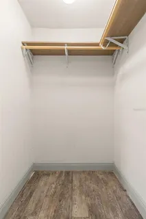 a view of walk in closet with empty racks
