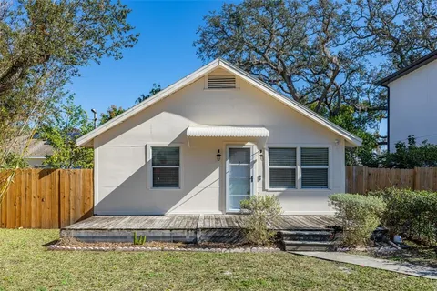 a view of a house with backyard and trees
