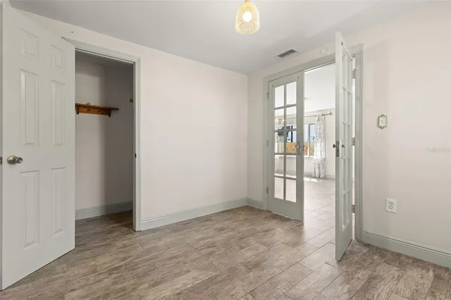 an empty room with windows and closet