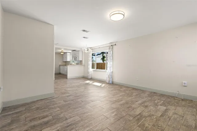 wooden floor in an empty room with a window