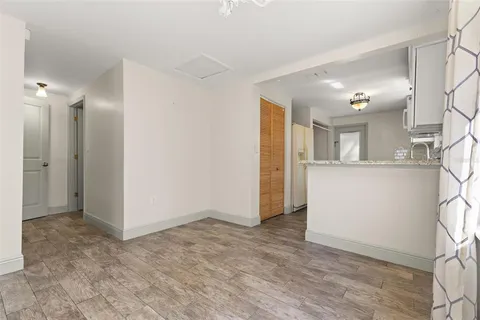 a view of a kitchen with a sink and a refrigerator