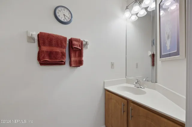 a bathroom with a sink vanity and a mirror