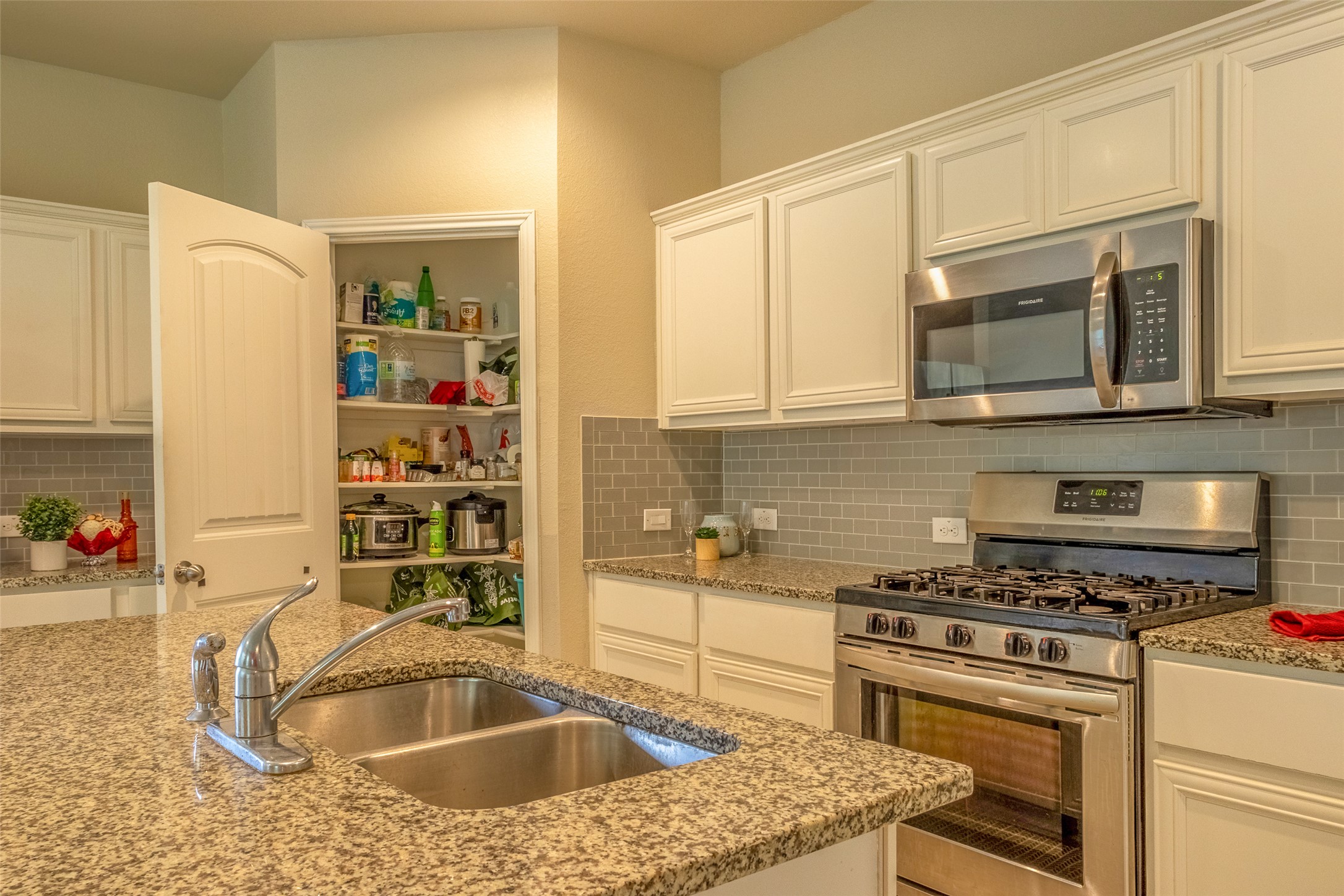 7225 Ranchito Drive Austin, TX 78744 - Photo 14 of 39 Culinary creations come to life in this kitchen, featuring ample countertop space and a well-organized pantry.