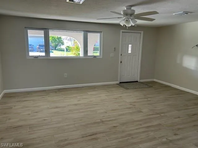 a view of an empty room with a window