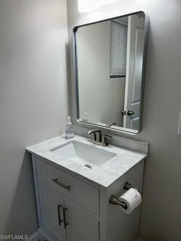 a bathroom with a sink and mirror