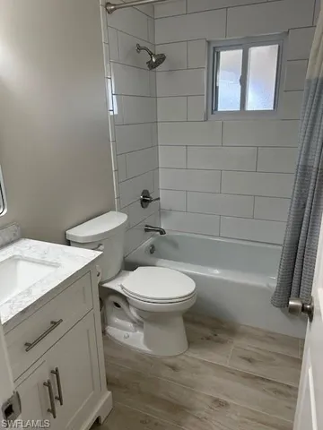 a bathroom with a toilet a sink and bathtub