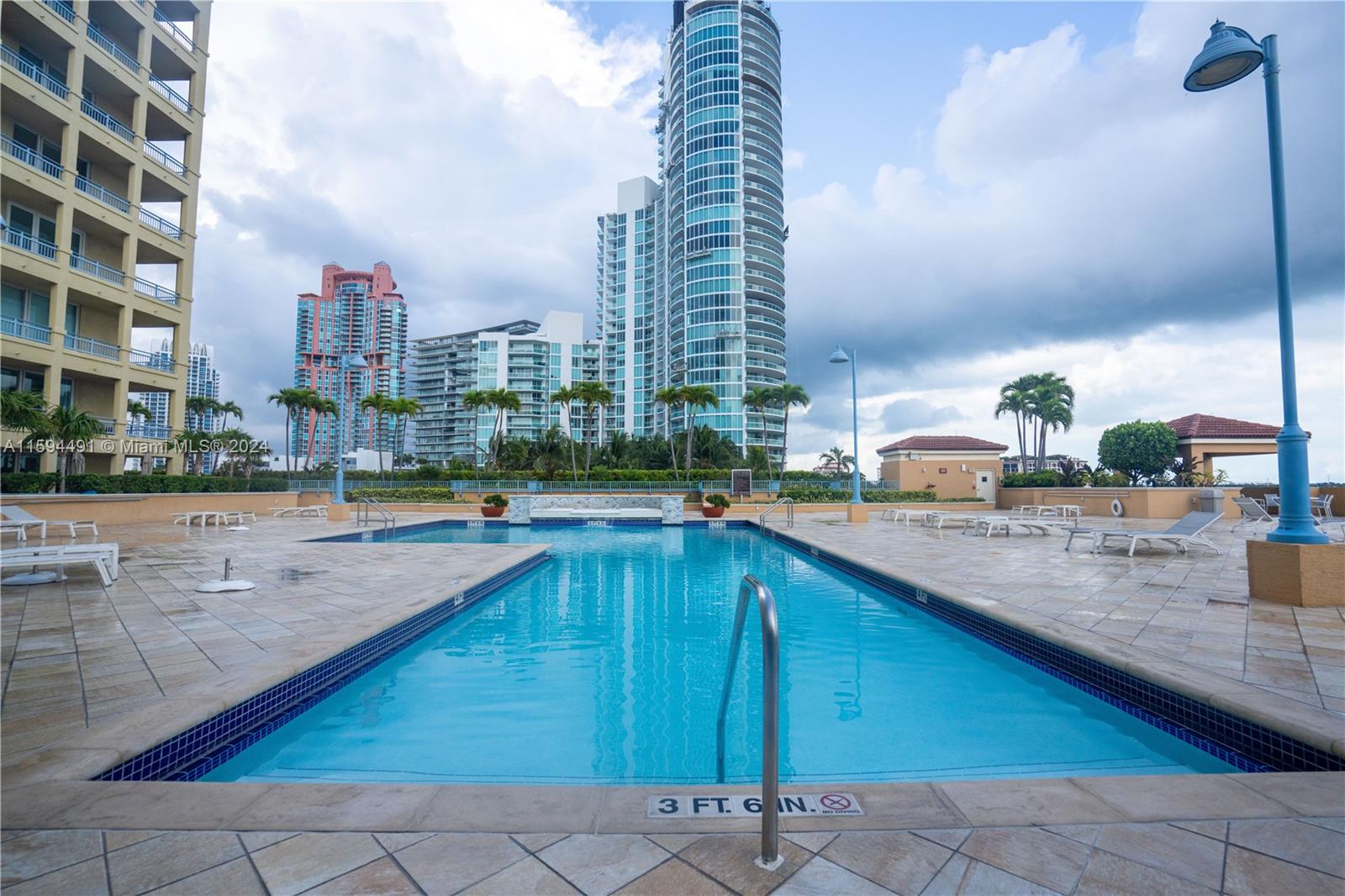90 Alton Road, Unit 2807 Miami Beach, FL 33139 - Photo 20 of 27 a swimming pool with outdoor seating and city view