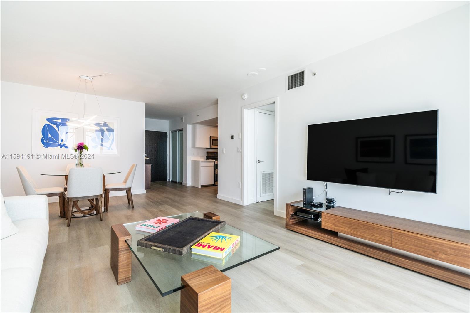90 Alton Road, Unit 2807 Miami Beach, FL 33139 - Photo 4 of 27 a living room with furniture and a flat screen tv