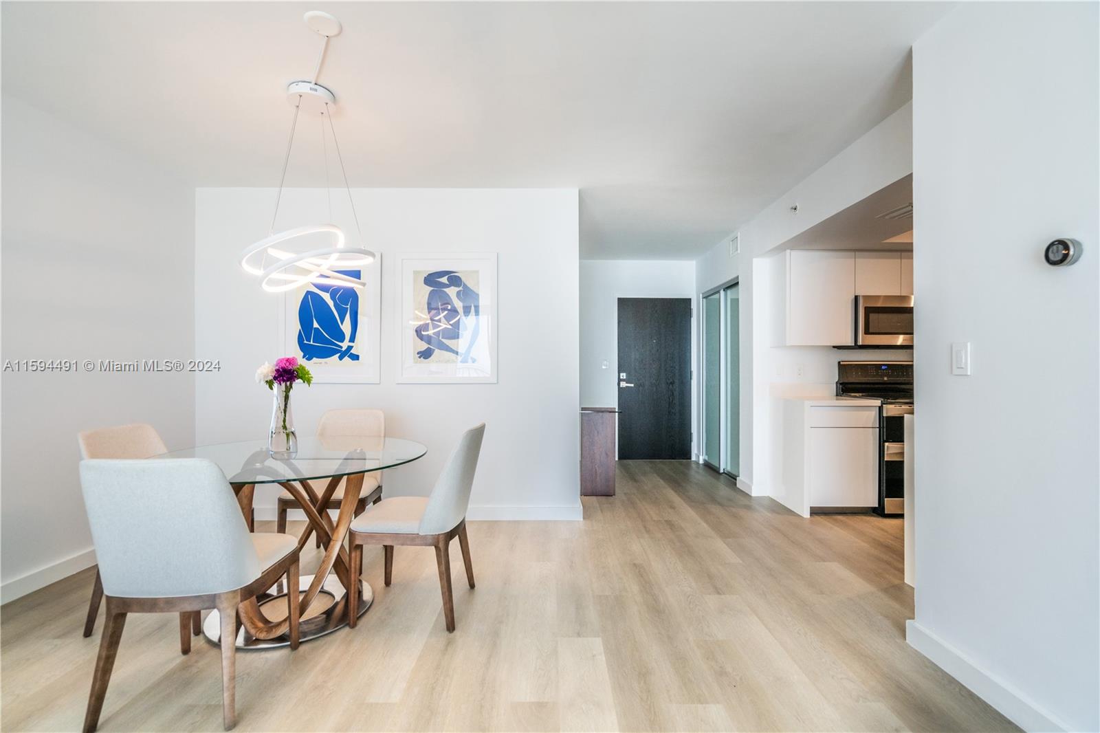 90 Alton Road, Unit 2807 Miami Beach, FL 33139 - Photo 5 of 27 a view of a dining room with furniture and wooden floor