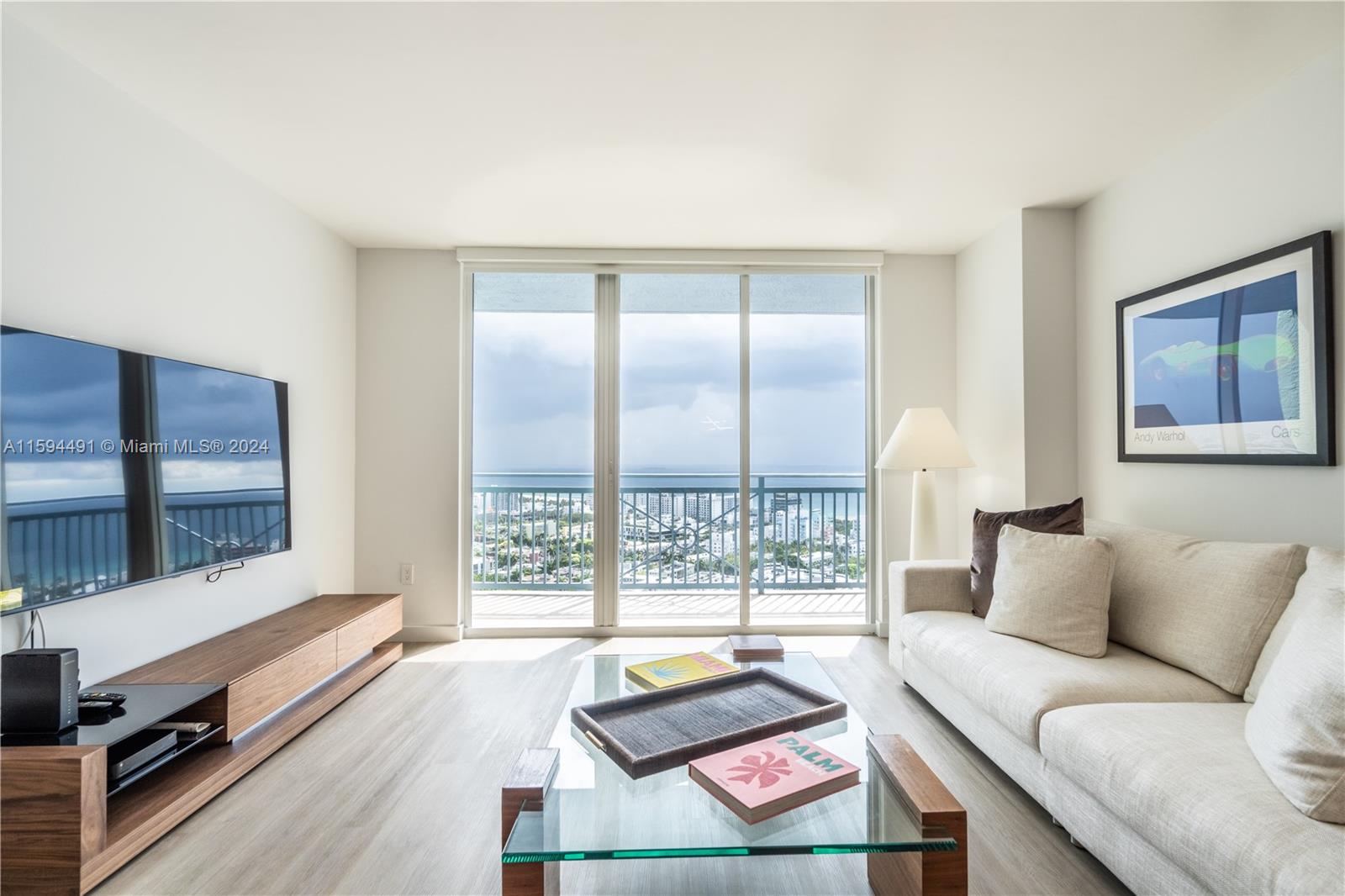 90 Alton Road, Unit 2807 Miami Beach, FL 33139 - Photo 6 of 27 a living room with furniture and a large window