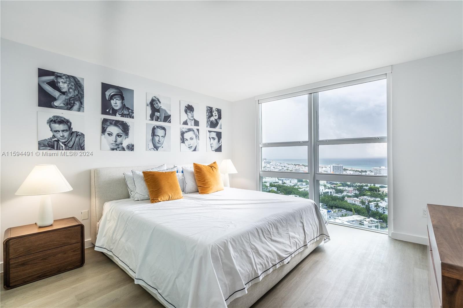 90 Alton Road, Unit 2807 Miami Beach, FL 33139 - Photo 10 of 27 a bedroom with a large bed and a large window