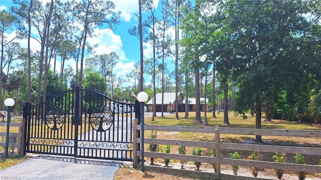 3690 27th Avenue Southwest Naples, FL 34117 - Photo 3 of 32 View of gate featuring fence