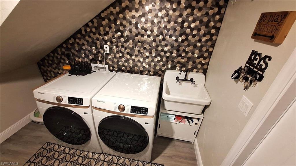 3690 27th Avenue Southwest Naples, FL 34117 - Photo 31 of 32 Laundry area with baseboards, laundry area, washing machine and dryer, and wood finished floors