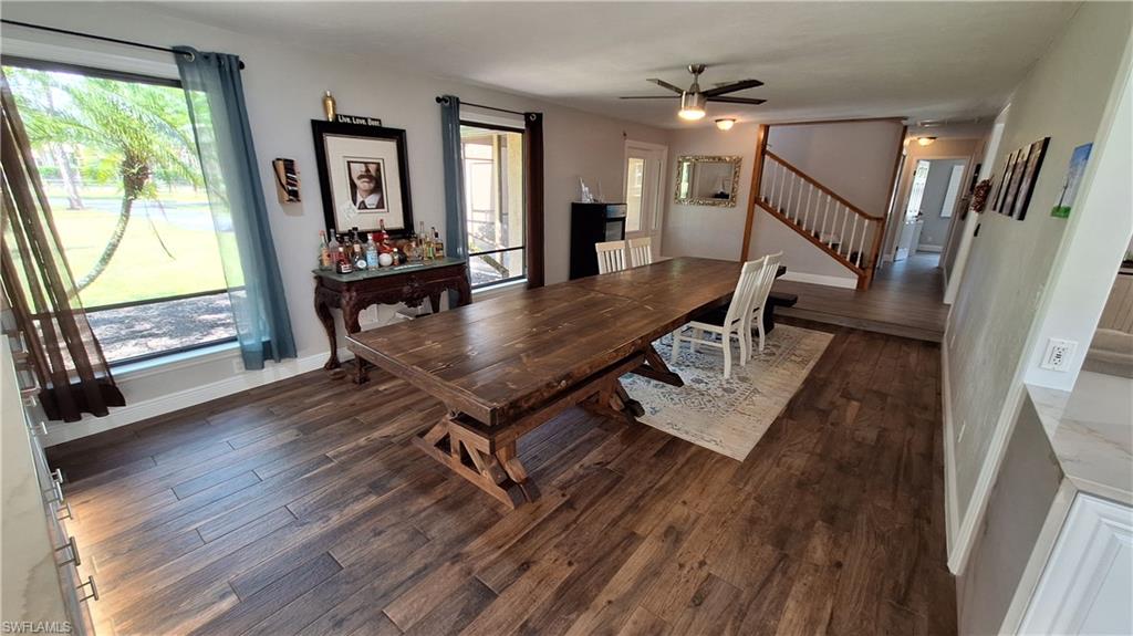 3690 27th Avenue Southwest Naples, FL 34117 - Photo 10 of 32 Dining area with dark wood-style flooring, stairway, and a ceiling fan