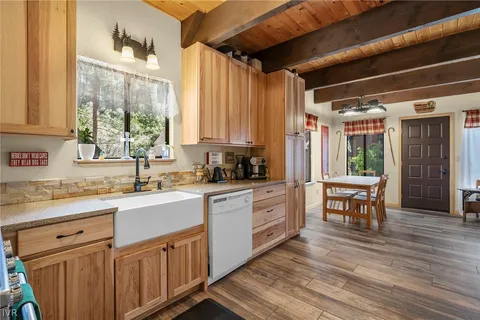 a kitchen with appliances cabinets and wooden floor