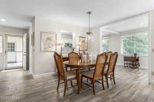 a dining room with furniture and wooden floor