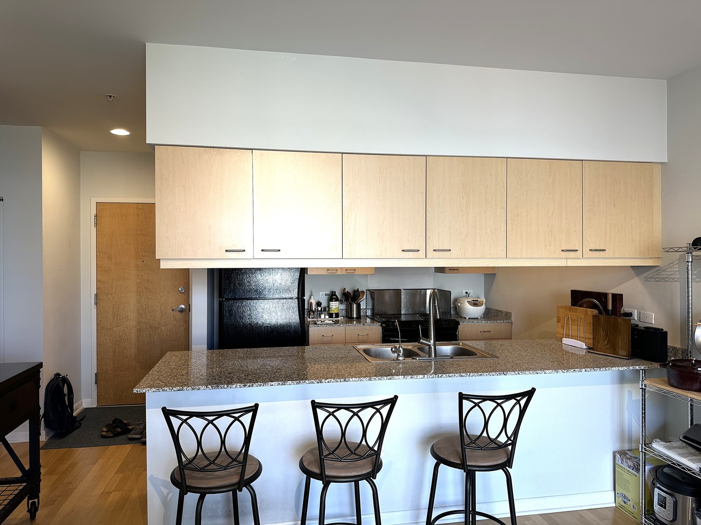 1720 Oak Avenue, Unit 706 Evanston, IL 60201 - Photo 10 of 27 a kitchen with stainless steel appliances kitchen island granite countertop a dining table and chairs