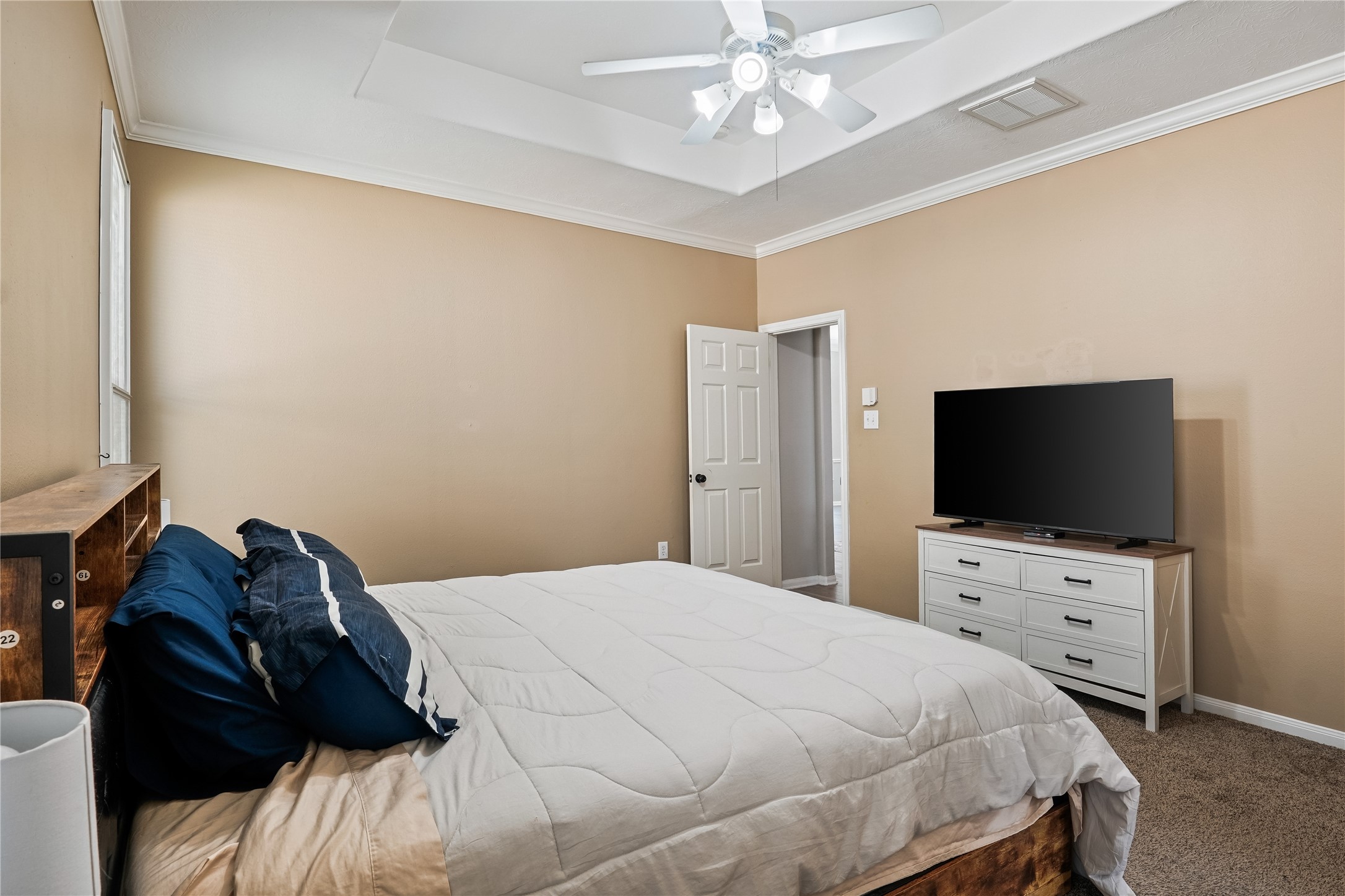 5710 Shady Hollow Court Rosharon, TX 77583 - Photo 15 of 25 a bedroom with a bed and a flat tv screen on dresser