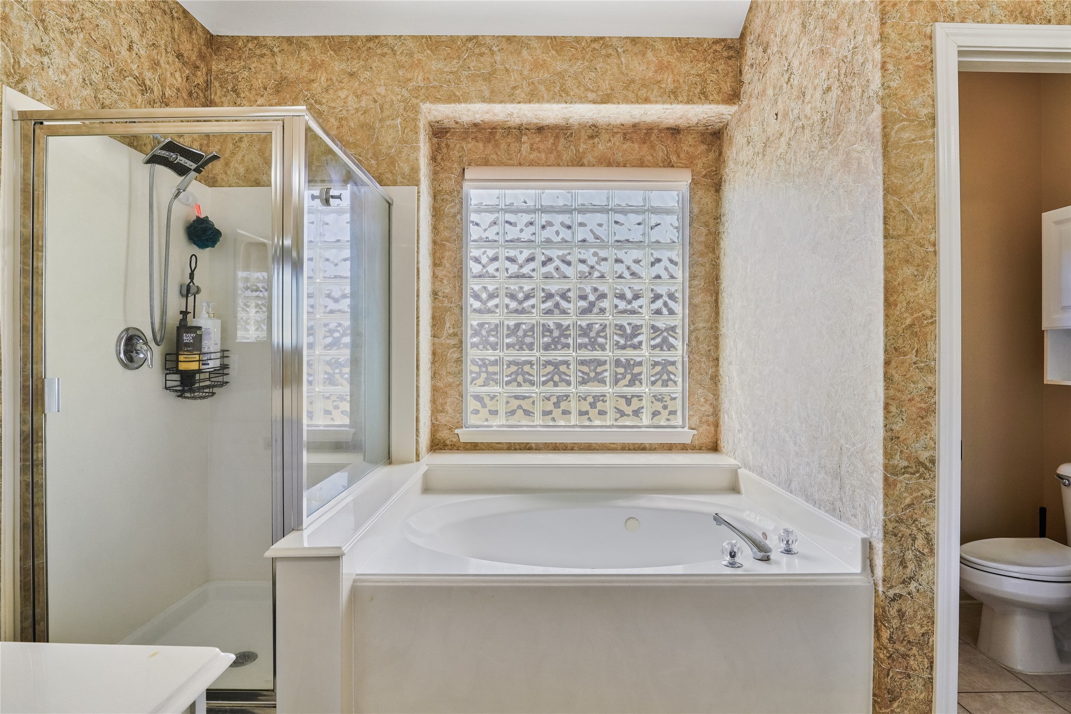 5710 Shady Hollow Court Rosharon, TX 77583 - Photo 16 of 25 a bathroom with a sink a toilet and shower