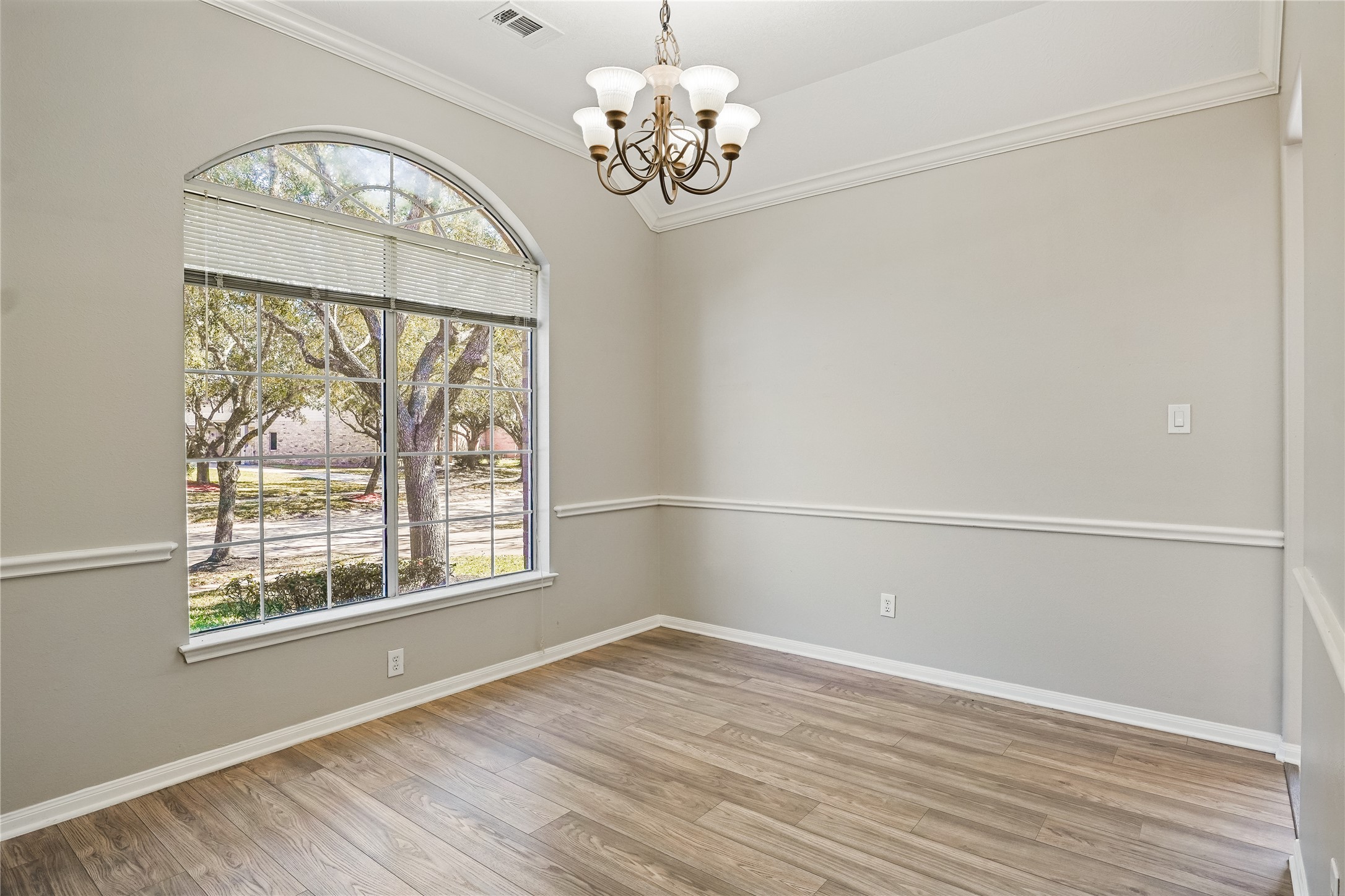 5710 Shady Hollow Court Rosharon, TX 77583 - Photo 3 of 25 a view of an empty room with a window and wooden floor