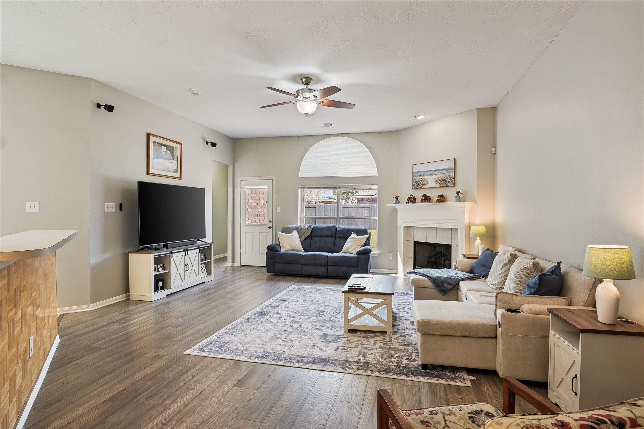 5710 Shady Hollow Court Rosharon, TX 77583 - Photo 5 of 25 a living room with fireplace furniture and a flat screen tv