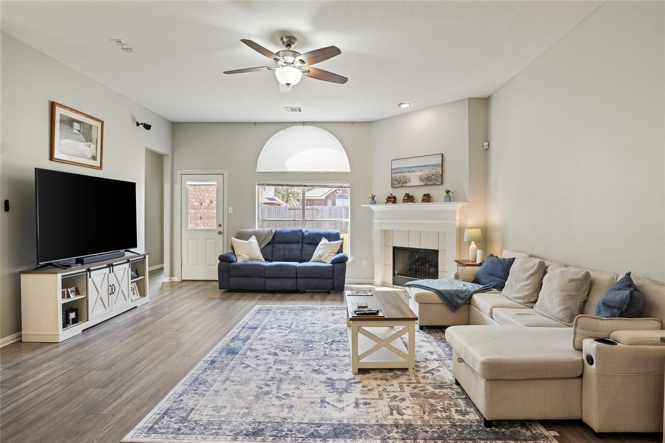 5710 Shady Hollow Court Rosharon, TX 77583 - Photo 8 of 25 a living room with furniture a fireplace and a flat screen tv