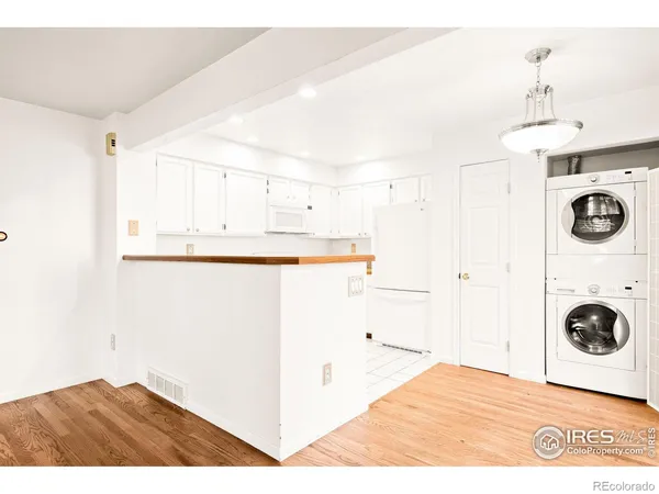 a view of a kitchen with wooden floor