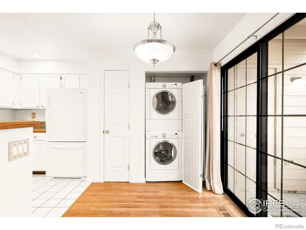 a view of a kitchen with a sink and refrigerator
