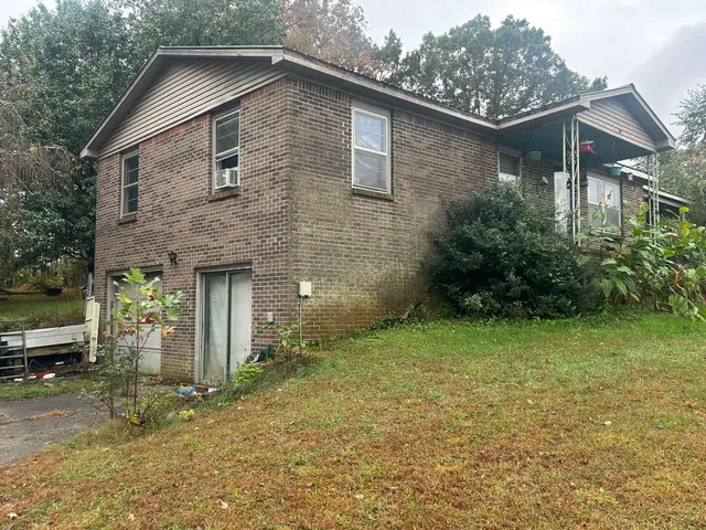 a backyard of a house with plants and garden