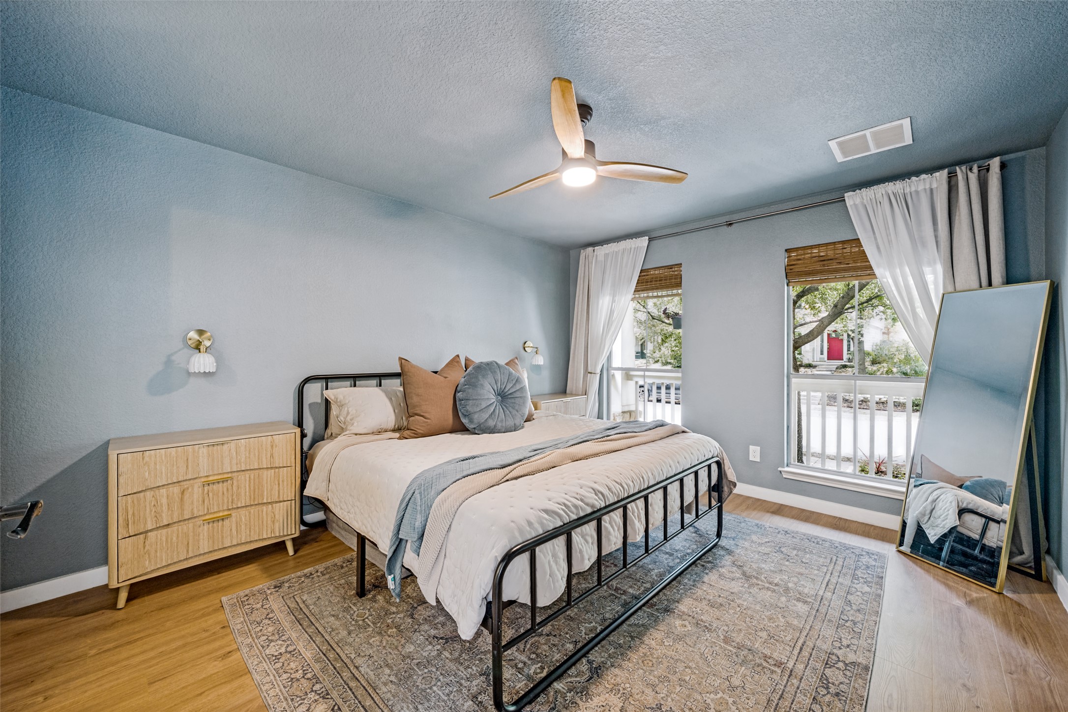 9205 Rowlands Sayle Road Austin, TX 78744 - Photo 15 of 25 Relax in this tranquil sleeping area, complete with a contemporary ceiling fan and light-filled windows.