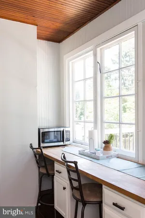 a view of a dining room with furniture and window