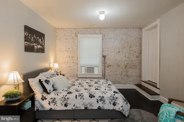 a bedroom with a bed and a night stand