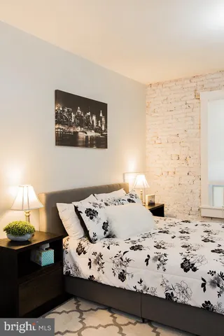 a bedroom with a bed and a couch