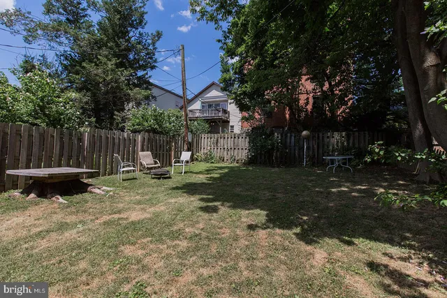 a view of a park with a bench and trees